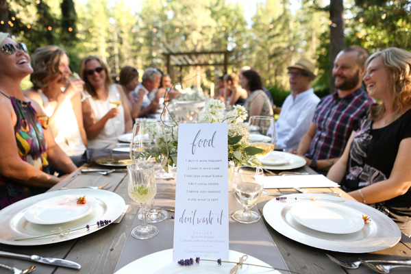 group of people gathered around the dinner table outdoors