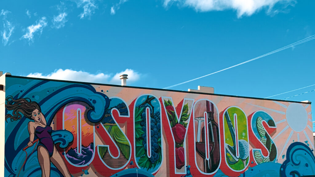 Mural that says Osoyoos with a different image in each letter, and a water skiier prominently featured. 